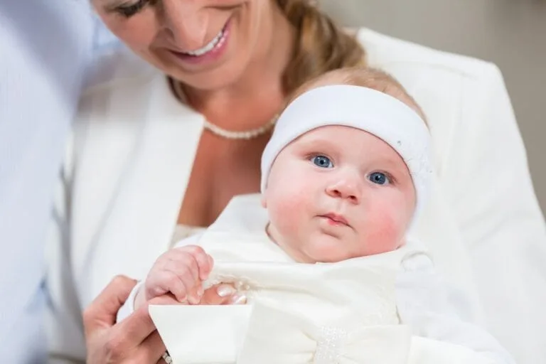 Mother Holding Baby at Christening